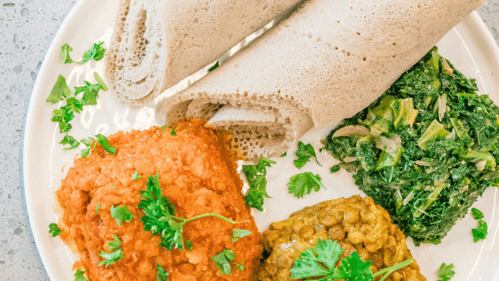 vegan Ethiopian food on plate: injera, lentils